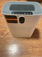 Front and side view of Morento white air purifier with power cord visible
