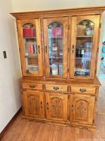 Full view of china cabinet showing upper glass doors and lower storage doors