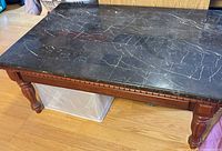 Full view of coffee table showing marble top and wood base