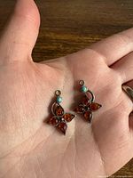 Both pendants in palm to show size and design