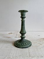 Full view of blue-green faux patina metal candlestick holder