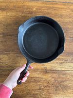 Top view of Findlay cast iron skillet showing interior cooking surface, one pour spout and handle