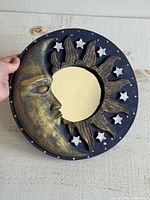 Front view of round moon and sun mirror