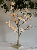 Full view of light-up flower branch on base