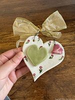 front view of ceramic heart ornament with ribbon