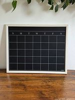 Front view of magnetic chalkboard calendar with wood frame
