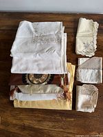 stack of folded assorted linens on wooden surface