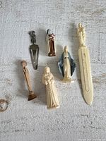 All six religious miniatures laid out on surface