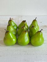 Front view of nine faux green pears in three rows