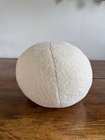 front view of off-white bouclé ball pillow