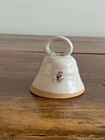 Stoneware bell front view showing flower design