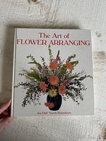 Front cover showing title, authors and floral arrangement image