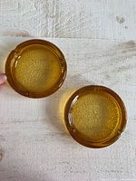 Top view showing both amber glass ashtrays