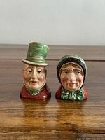 Front view of both Beswick Dickens Ware shakers