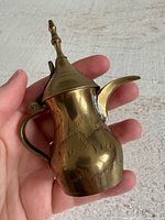 Side view brass miniature kettle showing etched design, handle, spout