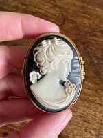 Front view showing cameo relief and gold-tone bezel