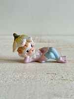 Full view of reclining pixie figurine