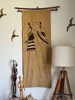 Full view of fabric wall hanging, hanger and surrounding objects for scale