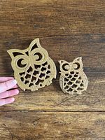Both owl metal trivets side by side for size comparison