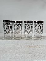 four silver overlay 25th anniversary glasses side by side