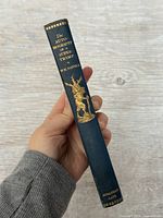 Spine view showing title, author, publisher, gilt stag illustration