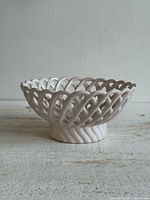 Front view of white ceramic lattice bowl showing full shape