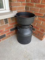 Milk can with basin stacked