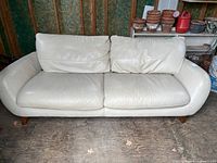 Front view of cream sofa showing overall style and condition