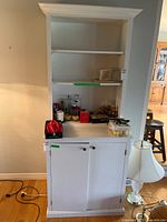 Full frontal view showing shelves and cabinet doors