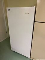Front and left side view of Kelvinator upright freezer