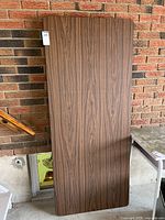 Full view of folding table leaning against wall