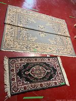 Both rugs side by side folded showing designs and size comparison