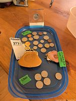Overview of all coins, commemorative, and two coin purses on blue lid
