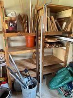 Wide view of shelving showing wood boards, trim bucket, laminate flooring box, galvanized pail