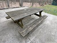 Full view of wooden picnic table on patio