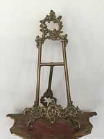 Front view of ornate brass easel