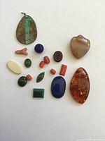 Group view of all gemstones and coral pieces on white background