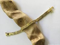 full bracelet laid flat on driftwood prop