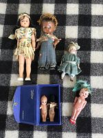 All six dolls laid out to show grouping and general condition