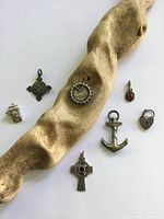 All seven sterling pieces arranged with driftwood for scale