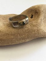 Front view showing bezel-set gemstone and square band profile