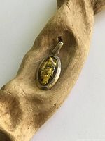 Front view of sterling silver pendant with amber cabochon