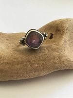 Front view of sterling silver ring with square purple glass stone