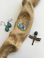 Front view of all jewelry displayed on driftwood showing design and color