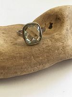 Front view of sterling silver ring with pale green faceted stone