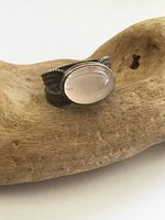 Front view of ring showing rose quartz cabochon and rope twist band