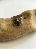 Front view showing garnet and bezel on textured band