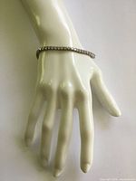 Bracelet worn on mannequin hand, full view