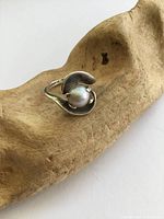 Front view of sterling silver ring showing pearl and setting