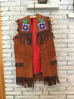 Full front view of suede vest showing fringe and beadwork